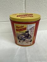 Full front view of the tin can showing vintage illustration and branding.