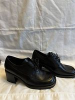 Pair of black leather women's autumn business shoes/boots by TRANSIT, size 38, shown from the side and top angles.