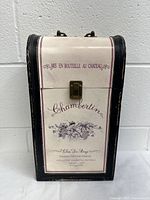 Front view of wine bottle case showing vintage label print and clasp