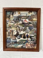 Front view of a wooden picture frame containing a collage of fish, people fishing, and beach/outdoor scenes photos.
