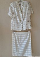 Full two-piece suit hung against wall