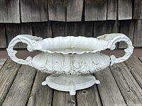 Front view of planter showing overall shape, twin handles, and decorative motifs