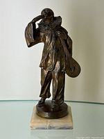 Full front view of bronze Pierrot figure on marble base