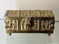 Front side view of the antique bronze box showing detailed Gothic relief design and latch clasp.