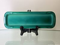 Front view of rectangular green malachite glass tray on display stand