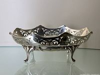 Front view of sterling silver dish showing pierced gallery and scroll feet