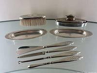 All items arranged on glass surface, front view