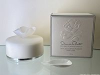 Full lot including the white opaque jar with frosted flower petal shaped lid, small white spatula, and embossed original box with branding.