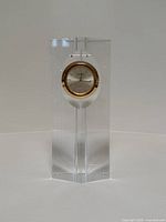 Full view of clear glass rectangular desk clock with gold bezel clock face inside