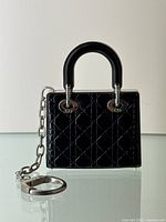 Front view of purse-shaped compact on white background