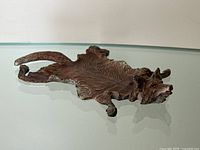 Angled view of wolf pelt dish on reflective surface