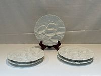 Overall view of five plates arranged with one on stand and stacks in front