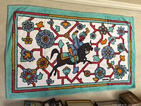 Full view of towel laid flat showing overall design and border