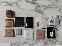 Full lot overview showing all perfume samples and soaps arranged neatly on marble surface