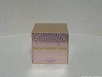 Front view of the boxed Lalique L'Amour perfumed body cream highlighting design and branding.
