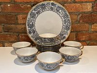 Wide arrangement of 6 cups, 7 saucers stacked and 13in platter