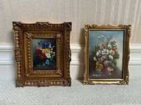Two framed floral oil paintings side by side against a wall
