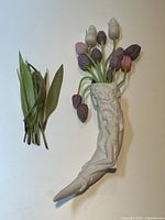 Overhead view of horn vase with glass tulip stems and loose leaf stems