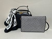 Front view of three items: woven crossbody bag, leather handbag with top handle and attached scarf