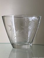 Front view of the clear cut crystal vase with detailed flower and ladybug engravings visible.