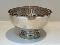 Front view of bowl with lid attached, showing overall shape and condition