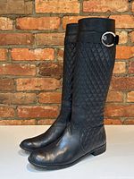 Angled front-left view showing profile of both boots against brick background