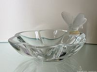 Front three-quarter view of clear crystal bowl and frosted butterfly perched on rim