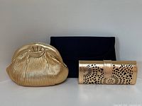 All three clutches side by side on white background