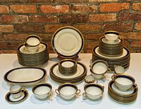 Overview of full set arranged on table against brick wall