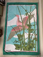 Full front view of towel laid flat showing entire bird and foliage design