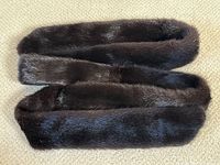 Vintage dark brown mink fur belt stole laid out to show length and color.
