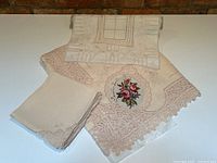 Overview showing both tablecloths and stack of linen napkins