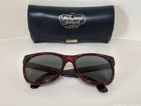 Front view of vintage tortoiseshell frame sunglasses with dark lenses, showing condition and style.