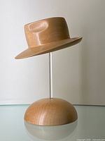 Full view of hand-carved wood fedora hat sculpture mounted on clear acrylic rod and wooden dome base