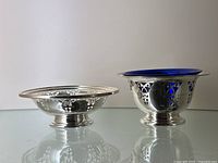 Both dishes side by side on glass tabletop, front view