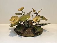 Front view of vintage toleware sculpture showing mushrooms, buttercups, leaves, butterfly, and circular hammered base.