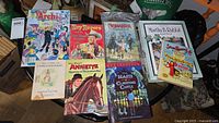 Lot of nine vintage children's books and comic books shown from front covers with illustrations and titles about Archie, Roy Rogers, Bonanza, Martha B. Rabbitt, Annette, Beasts of Clawstone Castle, Peter Rabbit, Super Ranger.