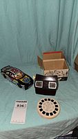 View of the lot showing the View-Master viewer, one reel, box, and the die cast car.