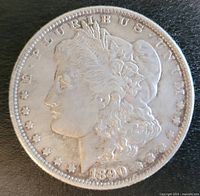 Front side of 1890 Morgan Silver Dollar showing Lady Liberty profile with date and inscriptions.