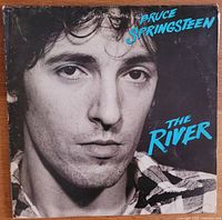 Front cover of Bruce Springsteen's album 'The River', featuring a close-up black-and-white photo of the artist and blue text.