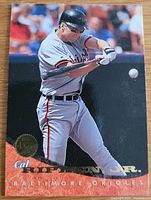 Front of 1994 Donruss Leaf Cal Ripken Jr. baseball card, card #1 showing batting image, Baltimore Orioles colors, and gold emblem.