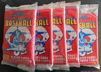 Five sealed packs of 1988 Score Major League Baseball player and trivia cards stacked side by side with clear plastic wrapping.