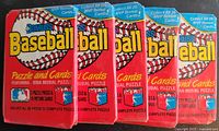 Five unopened wax packs of Donruss 1988 Baseball Cards arranged side by side showing front packaging with baseball graphics and promotional text