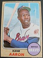 Front of the card showing Hank Aaron in Braves uniform holding a bat.