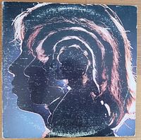 Front cover of the double vinyl album featuring layered silhouette profiles of band members.
