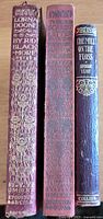 Photo showing the spines of the three vintage hardcover novels with decorative text and patterns.