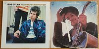 Front covers of both Bob Dylan albums: Highway 61 Revisited on left, Nashville Skyline on right.