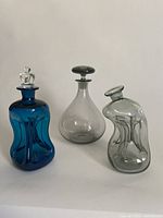 Photo showing all three decanters: turquoise blue Kluk Kluk, smoke grey Ramona and smoke grey Kluk Kluk decanter