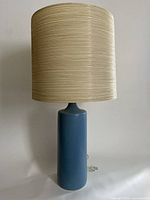 Full front view of lamp showing robin's egg blue cylindrical ceramic base with off-white original shade