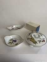 Photo showing full set of 5 Royal Worcester ‘Evesham’ serving pieces including 1 covered round dish, 1 oval dish, 1 round open dish, and 4 small ramekins along with original box for one ramekin